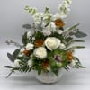 Adorned in a ceramic pumpkin keepsake container, this arrangement is full of