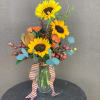 A beautiful fall arrangement with sunflowers, spray roses, curly willow, fall berries