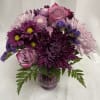 Purple and pink bouquet in a glass vase