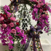 Purple orchid and pink rose wreath with skull ribbons