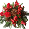 Red roses with pinecones and berries in a holiday bouquet