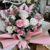Pink and white rose bouquet with carnations and eucalyptus wrapping