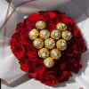 A heart-shaped cluster of velvety red roses set around a gleaming nest