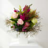 Mixed bouquet of pink and green flowers in a white vase