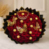 Bouquet of red roses with gold butterfly decorations and chocolates