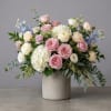 Pink and white roses with hydrangeas in a concrete vase