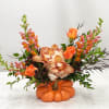 A beautiful fall arrangement in a ceramic fall pumpkin. 