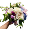 Handheld bouquet of white roses, tulips, and pastel hydrangeas