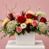 Mixed bouquet of red and pink roses in a white rectangular vase