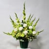 White roses and green flowers in a dark vase