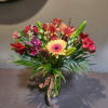 Mixed bouquet with gerbera daisies, alstroemeria, and snapdragons in a glass vase