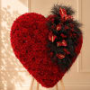 Heart-shaped red rose arrangement on a wooden stand