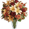Roses, lilies and oak leaves create a fantasy of fall flowers. Send