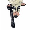 Cow-shaped floral tribute with white and pink flowers and a black ribbon