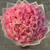 Pink rose bouquet with a pearl bow and translucent wrap