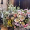 Large pastel flower arrangement in a woven basket