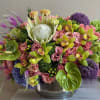 Colorful mixed floral arrangement in a silver bowl vase