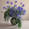 Blue iris arrangement in a green vase