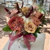 Autumnal fresh flower arrangement in a clear glass vase. 