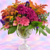 Colorful bouquet in a clear glass pedestal vase