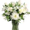 White roses and daisies arranged in a glass vase