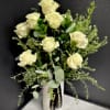 Cream roses in a white vase with airy greenery