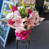 Pink and white lilies, hot-pink roses, chrysanthemums and carnations with green accents