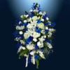 Blue and white floral spray with ribbon on a dark background