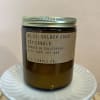 Amber jar candle with a metal lid and paper label