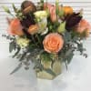 Collection of peach colored roses, ranunculus, alstroemeria, Lisianthus, wax flowers, and more