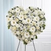 Heart-shaped white floral standing spray on an easel