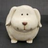 Ceramic dog figurine with a rounded face and small black eyes