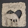 Stone memorial plaque with a horse relief and heart cutout