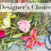 Assorted flowers and stems laid out with scissors and a glass bowl