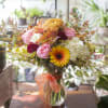 Vibrant, warm and colorful blooms arranged in a clear glass vase with