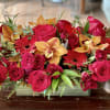 Red and gold blooms arranged in a wooden box.