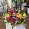 Mixed bouquet with pink and yellow blooms in a low arrangement