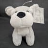 White plush teddy bear with a Burton + Burton tag