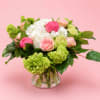 Pink and white flower arrangement in a clear glass vase