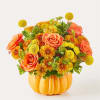 Orange roses and yellow mums arranged in a pumpkin-shaped vase