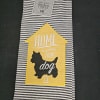 Striped kitchen towel with a yellow house patch and dog silhouette