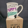 White mug with a dog-themed quote sitting on a cardboard box