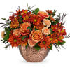 Orange and red mixed bouquet in a textured vase