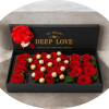 A lush cluster of velvety red roses paired with gold-foil chocolates makes