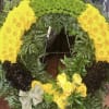 Yellow floral wreath with roses and chrysanthemums on a stand