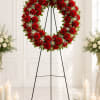 A beautiful arrangement of classic red carnations complete with soft, delicate baby's
