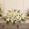 White and cream floral casket spray with roses and lilies