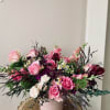 A dozen of gentle pink roses surrounded by the deeper tone flowers