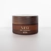 Brown balm jar with a wooden lid on a white background