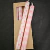Pink polka dot and striped candles in a cardboard package